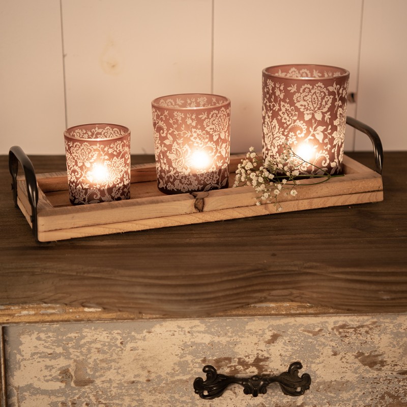 Un set di candele aromatiche diverse in vasetti di vetro marrone